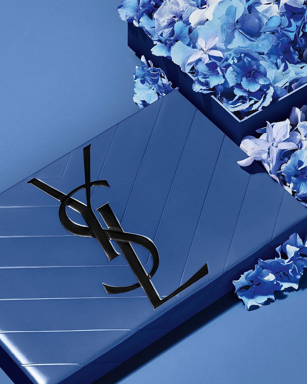 YSL Father's Day blue gift set, featuring the iconic Cassandre logo, overflowing with delicate blue floral accents.